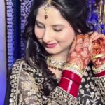 a women in black lehenga with makeup and jewellery posing