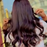 women showing her red hot grape highlighted hair