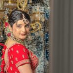 women in red bridal wear with makeup and jewellery posing