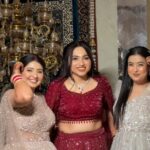 three women in wedding wear with makeup and jewellery ,happy posing