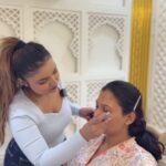 a makeup artist doing makeup on client