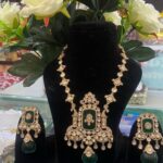 there is a jewellery showpiece which is bridal jewellery and have bottle green plus golden colour..