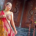 a model in bridal wear with jewellery and makeup posing