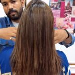 a women showcasing her brown highlighted straight hair