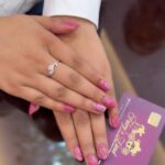 women hands with girly pink looking nails done
