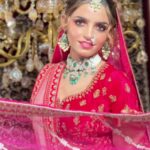 a women in red bridal wear wearing jewellery and makeup posing