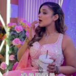 a women in pink lehenga with makeup on face posing
