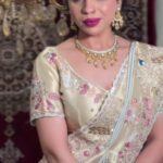 a women in cream colour lehenga with jewellery posing elegant