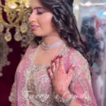 women in pink lehenga with pink subtle makeup posing