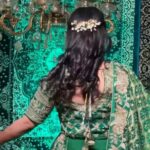 a women wearing bottle green lehenga showing her hairstyle