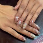a women showcasing her hand nails that is perfectly done