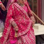 a women in bridal red wear walking down stairs