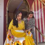 a women in yellow lehenga walking down stairs