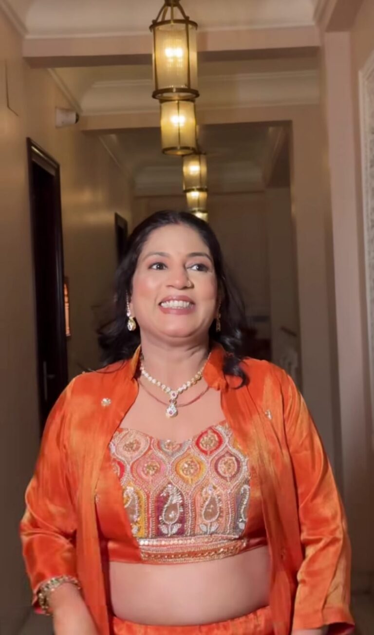 a women in orange lehenga , worn jewellery and makeup looking so good