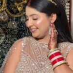 a women doing side pose , worn skin colour dress and also worn makeup and jewellery